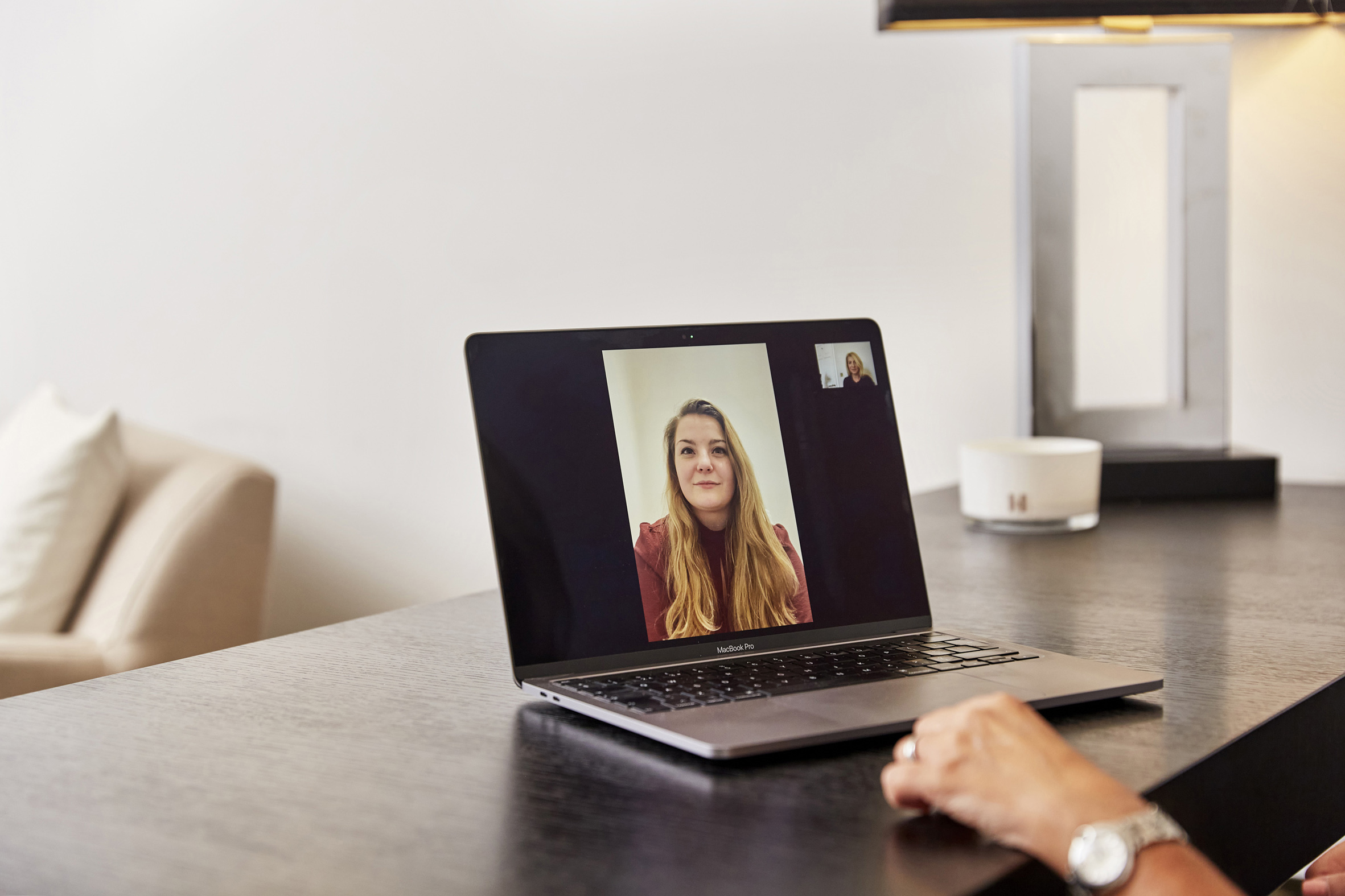Laptop on a desk displaying a virtual therapy session with a female client, conducted by a London-based psychology clinic, highlighting the convenience of online mental health support from The Chelsea Psychology Clinic.