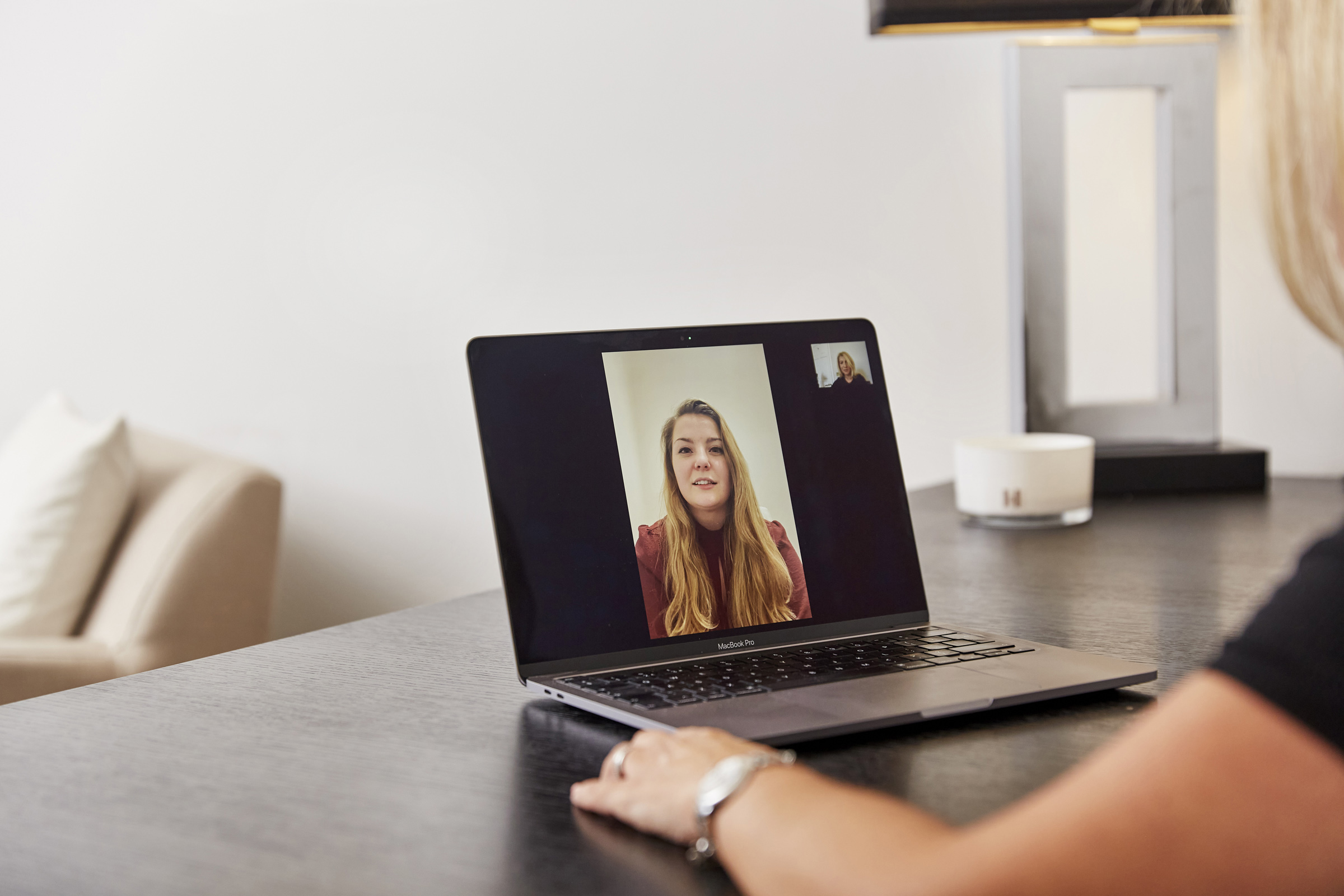 Laptop on a desk displaying a virtual therapy session with a female client, conducted by a London-based psychology clinic, highlighting the convenience of online mental health support from The Chelsea Psychology Clinic.